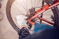 Biker lubricating oil for bicycle chains, Close-up Royalty Free Stock Photo