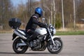 Biker man with his motorcycle on street and beautiful, enjoying freedom and active lifestyle, having fun on a bikers tour