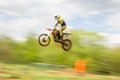 Biker on motocross jump in motion Royalty Free Stock Photo