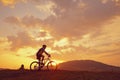 Biker mountain sun clouds