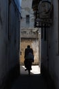 Biker in a narrow street in a city