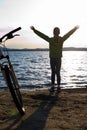 Biker person silhouette. Happy girl near bike