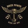 Biker power.Piston with wings on dark background.