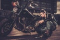 Biker repairing his custom motorcycle bobber