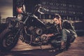 Biker repairing his custom motorcycle bobber