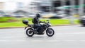 Biker ride Yamaha motorcycle on the city road with motion blurred background. Motorcyclist in black helmet and jacket