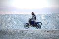 The biker rides enduro in a kaolin quarry
