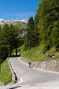 Biker rides serpentine mountain road in Tyrol alps