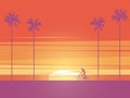 Biker riding bicycle at sunrise or sunset on the beach with palm trees in background. Symbol of active, healthy, sport