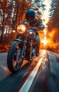 Biker riding motorcycle on asphalt road through the forest at sunset Royalty Free Stock Photo