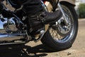 Biker riding a motorcycle. Bike and legs in leather cowboy boots