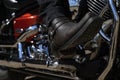 Biker riding a motorcycle. Bike and legs in leather cowboy boots