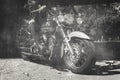 Biker riding a motorcycle. Bike and legs in leather cowboy boots. Vintage film look