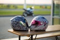 Biker romance. Male and female motorcycle helmets on the background of a motorcycle