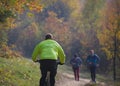 Biker and runners in the autumn forest
