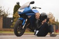 Biker sexy woman sitting about motorcycle. Outdoor lifestyle portrait Royalty Free Stock Photo