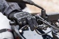 Biker sitting on motorcycle, close-up view on hands on handlebar Royalty Free Stock Photo