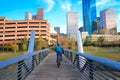 Biker on the street in Houston Texas Skyline with modern skyscrapers and blue sky view from park