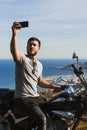 Biker taking a selfie with the landscape during a route