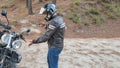 Biker talking on the phone to the insurance of his motorcycle after having suffered a breakdown on the road.