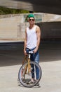 Biker with a tude. A handsome young man riding his bicycle outdoors.