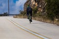 Biker uphill road on the mountain trying Royalty Free Stock Photo