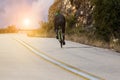 Biker uphill road on the mountain trying Royalty Free Stock Photo