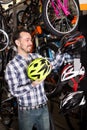 Biker 27-36 years old is choosing for himself comfortable helmet