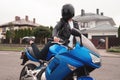 Biker young woman sitting on motorcycle. Outdoor lifestyle portrait Royalty Free Stock Photo