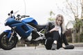 Biker young woman sitting on motorcycle. Outdoor lifestyle portrait Royalty Free Stock Photo