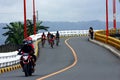 Bikers and motorcycle riders cross the Tumana Bridge in Marikina City. Royalty Free Stock Photo