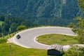 Bikers in mountain road in action ride, traveling across Europe, motorcycle tour, curve highway in mountains, copy space, extreme