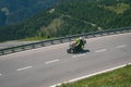 Bikers in mountain road in action ride, traveling across Europe, motorcycle tour, curve highway in mountains, copy space, extreme