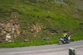 Bikers in mountain road in action ride, traveling across Europe, motorcycle tour, curve highway in mountains, copy space, extreme