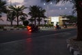 Bikers ride at night on the highway on Al-Marjan Island. United Arab Emirates