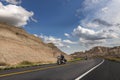 Bikers riding their chopper motorcycles on a dirt road at the Badlands National Park