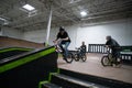 Bikers and skaters are practicing their tricks inside Royalty Free Stock Photo