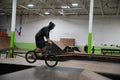 Bikers and skaters are practicing their tricks inside Royalty Free Stock Photo