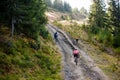 Bikers travel in difficult conditions in autumn forest Royalty Free Stock Photo