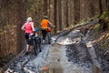Bikers travel in difficult conditions in autumn forest Royalty Free Stock Photo