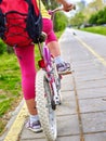 Bikes bicyclist girl. Children feet and bicycle wheel. Low section. Royalty Free Stock Photo