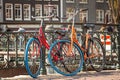 Bikes on the bridge in Amsterdam Netherlands. Classic bicycle parked on canal bridge. Amsterdam cityscape Royalty Free Stock Photo