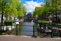 Bikes on the bridge that crosses the canal in Amsterdam Royalty Free Stock Photo