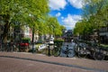 Bikes on the bridge that crosses the canal in Amsterdam Royalty Free Stock Photo