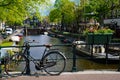 Bikes on the bridge that crosses the canal in Amsterdam Royalty Free Stock Photo