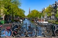 Bikes on the bridge that crosses the canal in Amsterdam Royalty Free Stock Photo