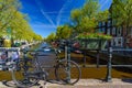 Bikes on the bridge that crosses the canal in Amsterdam Royalty Free Stock Photo