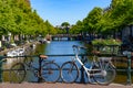 Bikes on the bridge that crosses the canal in Amsterdam Royalty Free Stock Photo