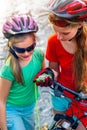 Bikes cycling children girl wearing helmet look at compass. Royalty Free Stock Photo