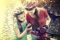 Bikes cycling children girl wearing helmet look at compass. Royalty Free Stock Photo